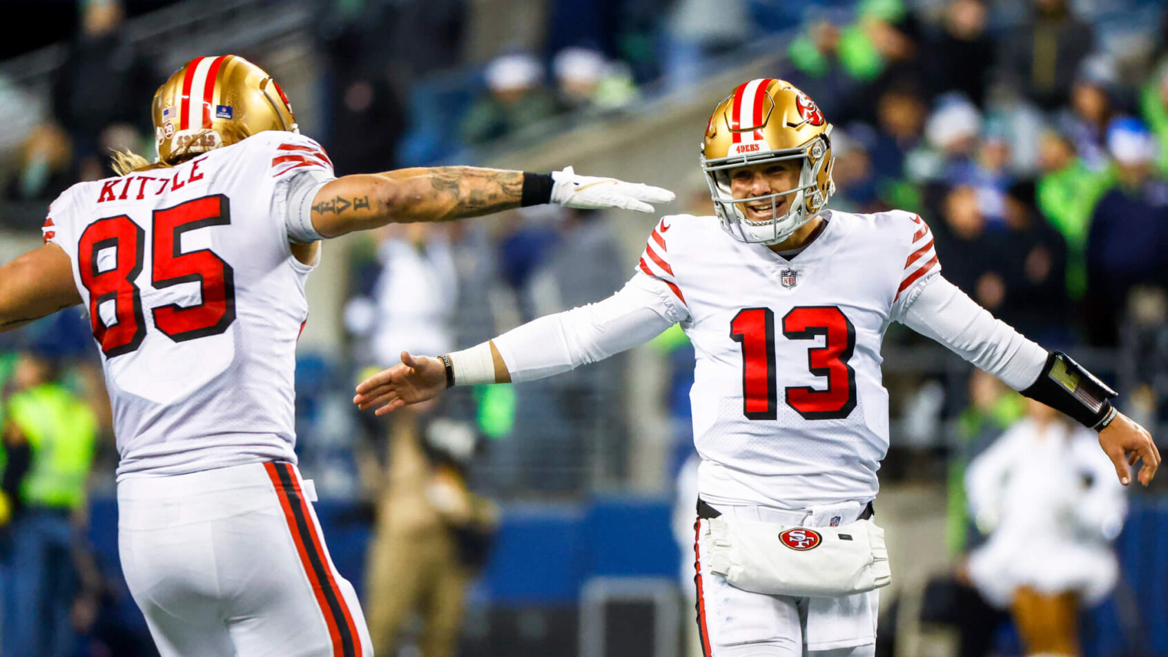 George Kittle and Brock Purdy high-five