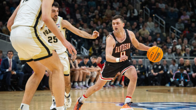 Foster Loyer dribbling away from defenders