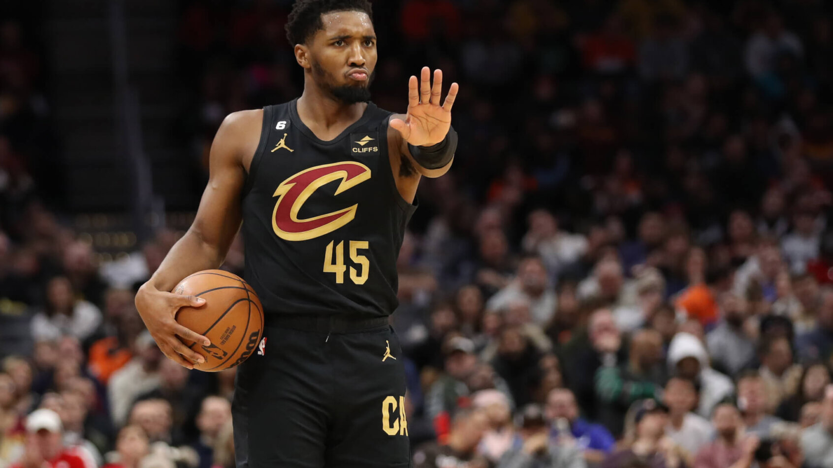 Donovan Mitchell waves off a teammate