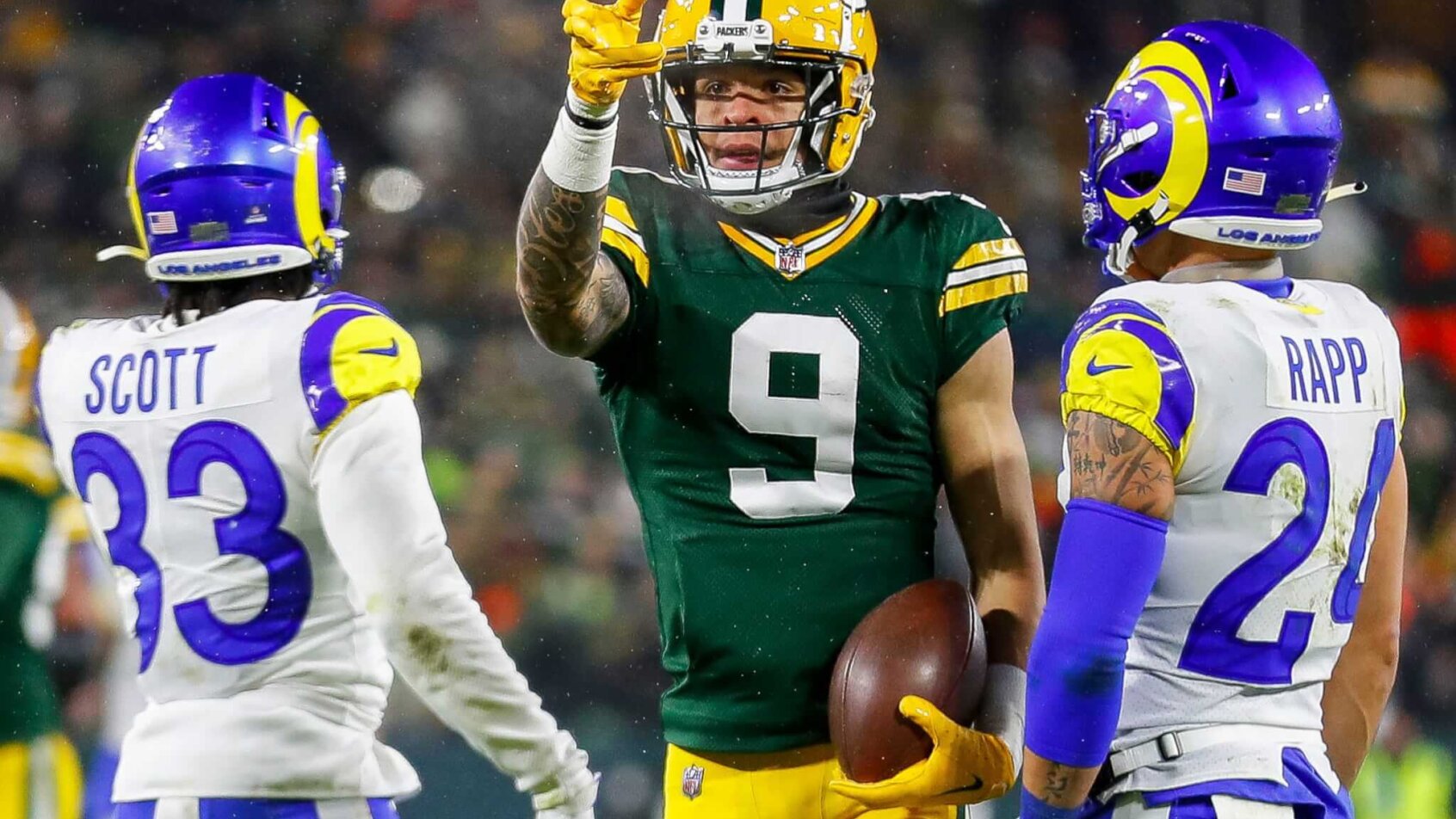 Christian Watson pointing, signaling first down