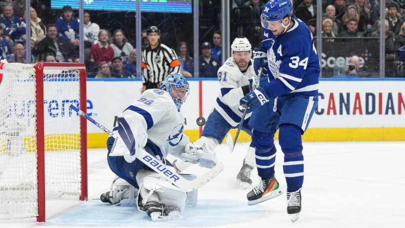 oronto Maple Leafs center Auston Matthews battles for the puck in front of Tampa Bay Lightning goaltender Andrei Vasilevskiy
