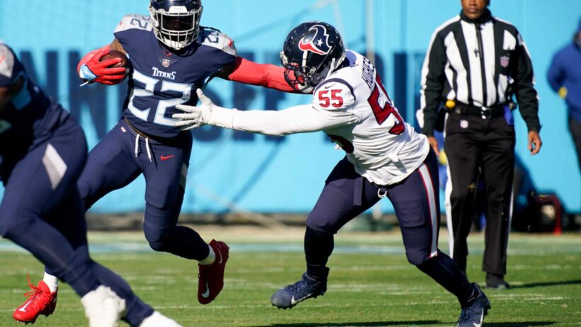 Tennessee Titans running back Derrick Henry wards off Houston Texans defensive end Jerry Hughes