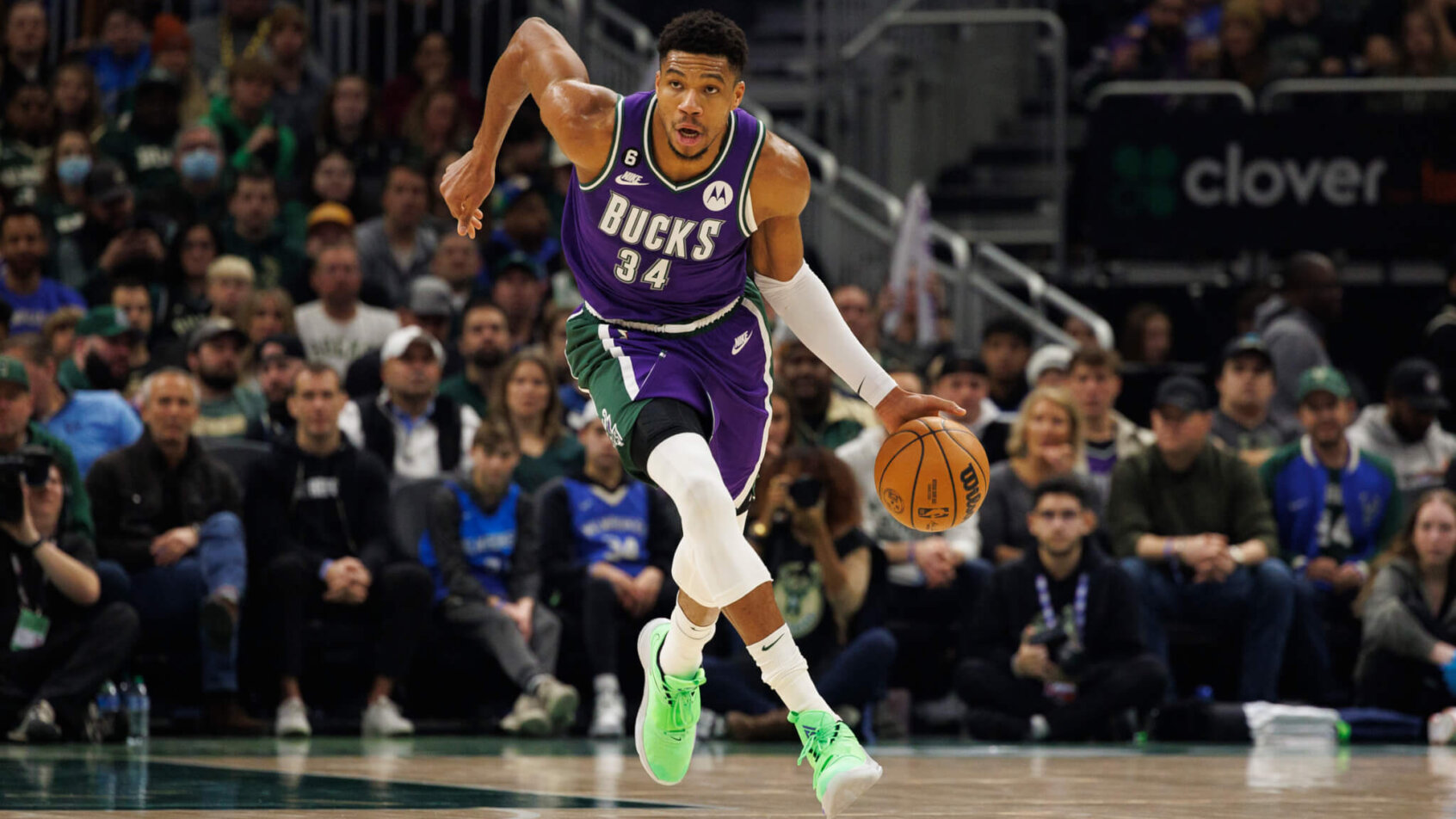 Giannis Antetokounmpo dribbles the ball up court.