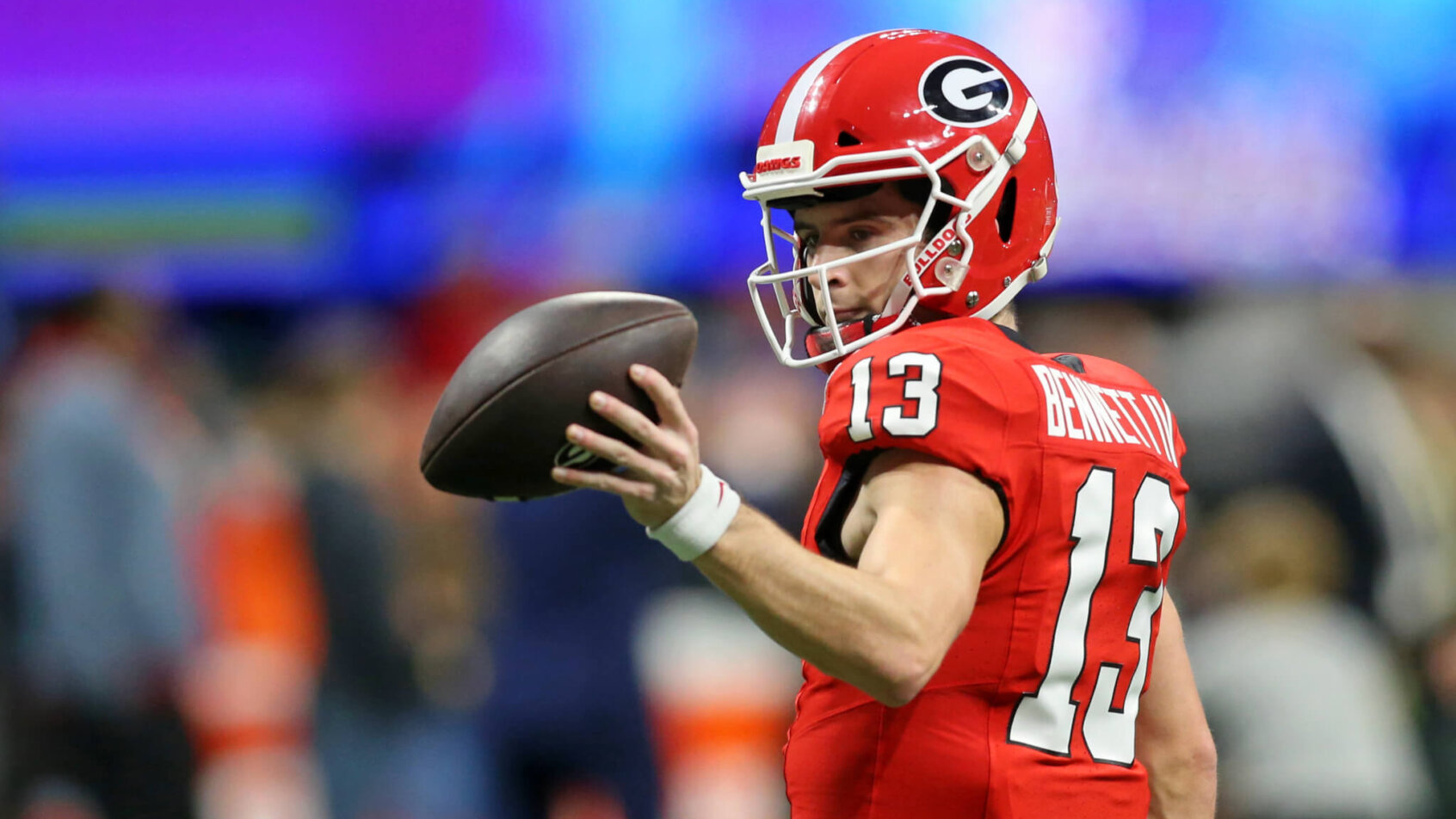 Stetson Bennett holding football with left hand