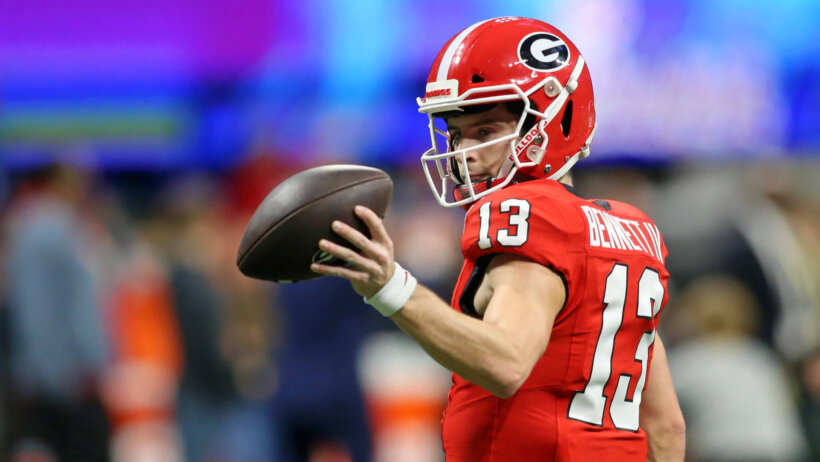 Stetson Bennett holding football with left hand