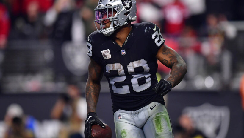 Josh Jacobs holding football