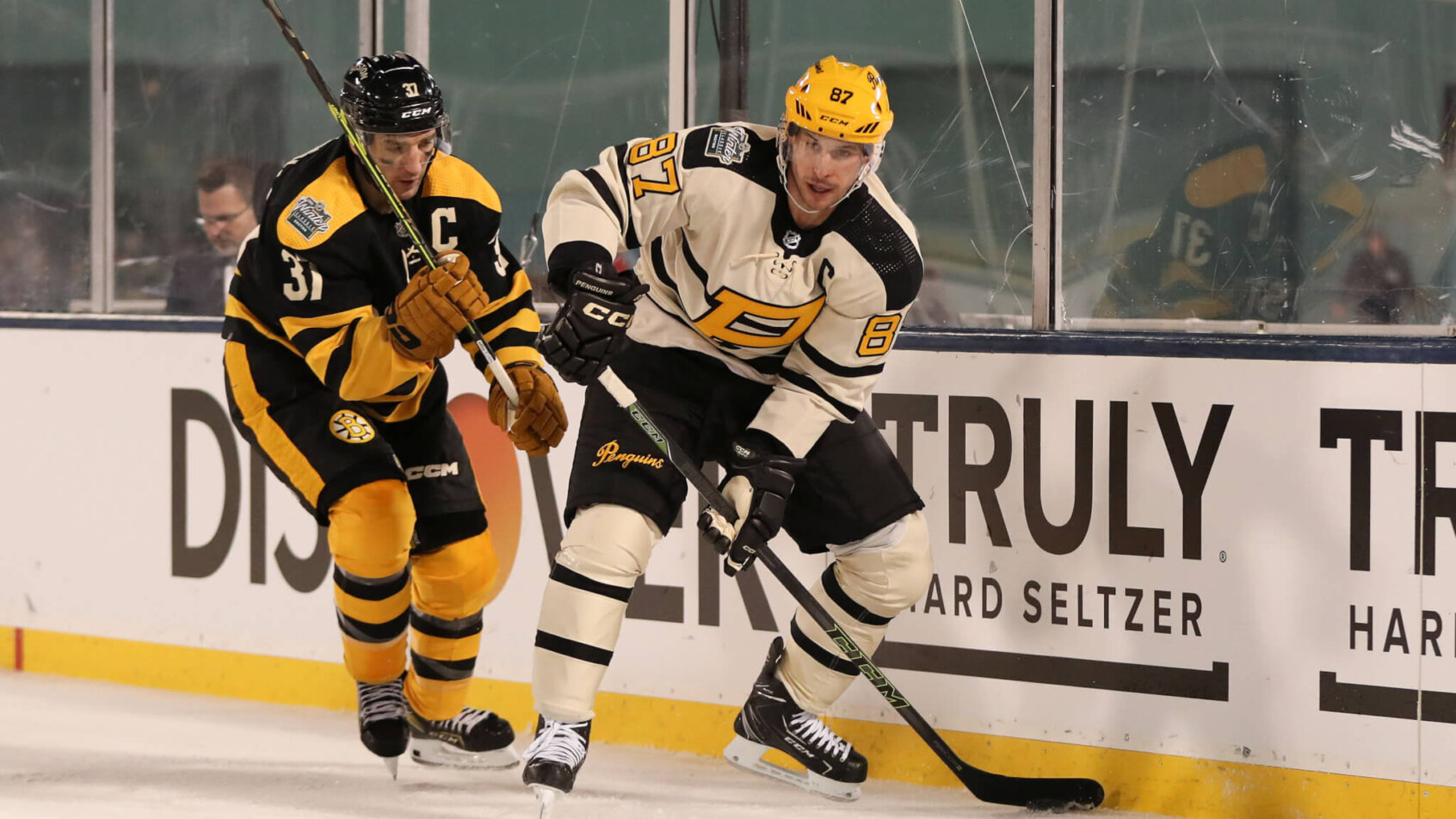 Pittsburgh Penguins Sidney Crosby and Boston Bruins Patrice Bergeron battle along the boards