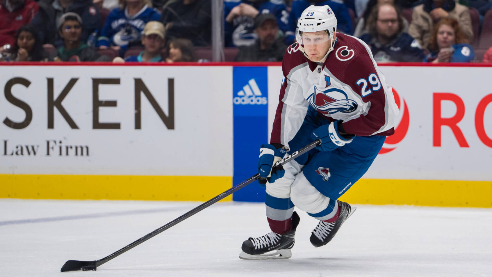 Colorado Avalanche forward Nathan MacKinnon skates with the puck
