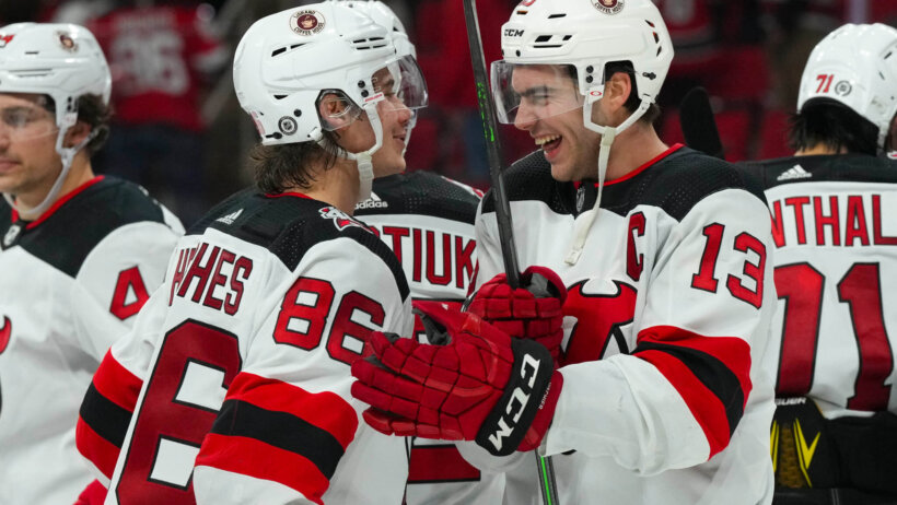 New Jersey Devils center Nico Hischier and center Jack Hughes celebrate victory