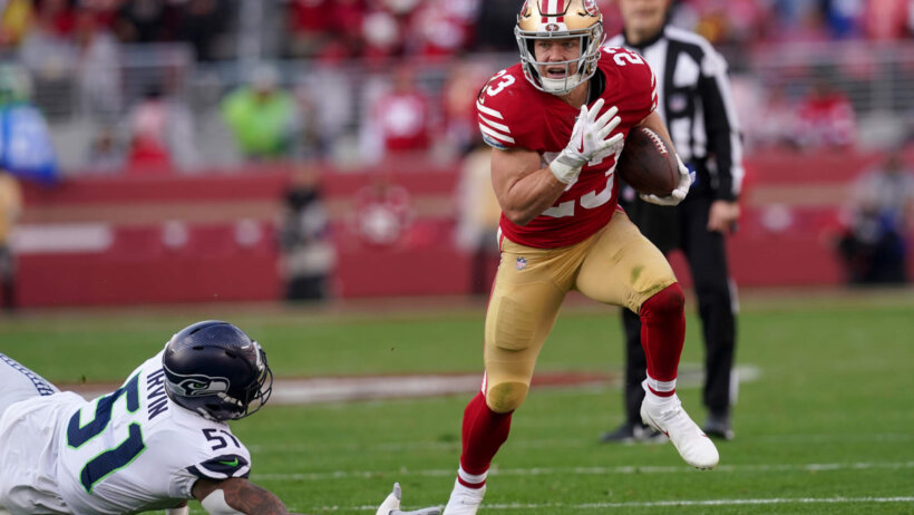 San Francisco 49ers running back Christian McCaffrey running past a defender