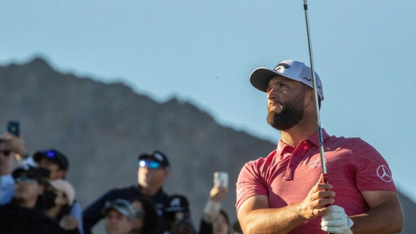 Jon Rahm watches a tee shot