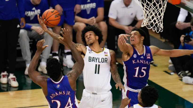 Jalen Bridges battles in the post versus two Kansas defenders.