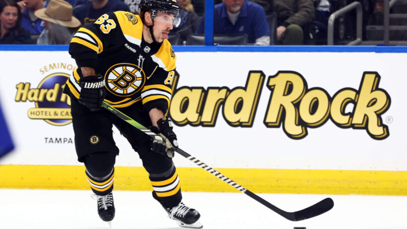 Boston Bruins left wing Brad Marchand skates and scores a goal