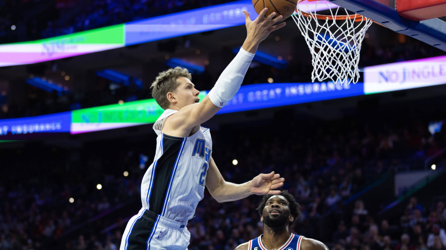 Mo Wagner drives on Joel Embiid in the Magic vs 76ers game