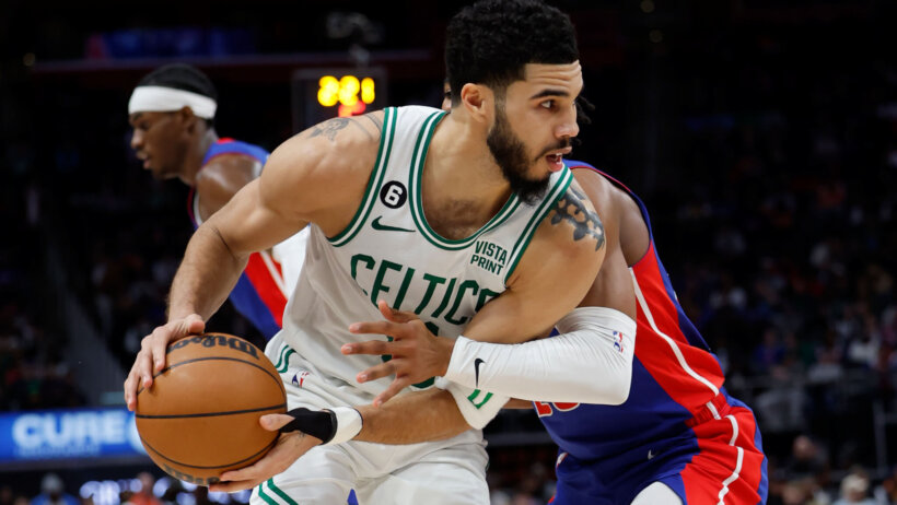 Jayson Tatum posts up a Pistons defender