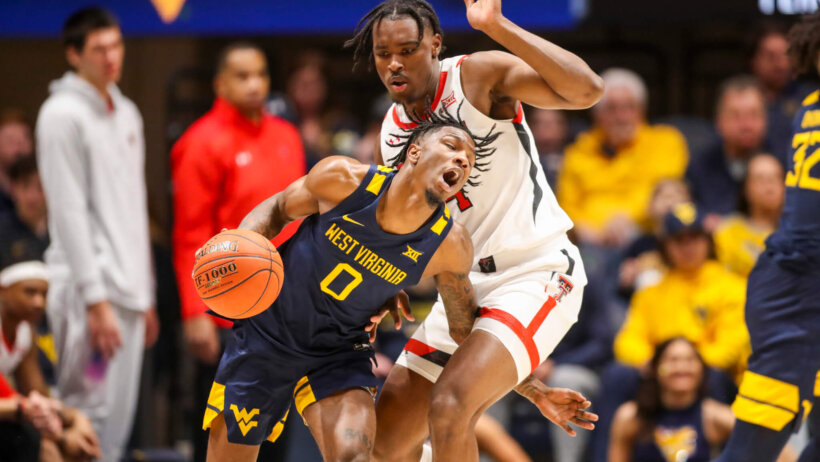 West Virginia Mountaineers guard Kedrian Johnson getting fouled