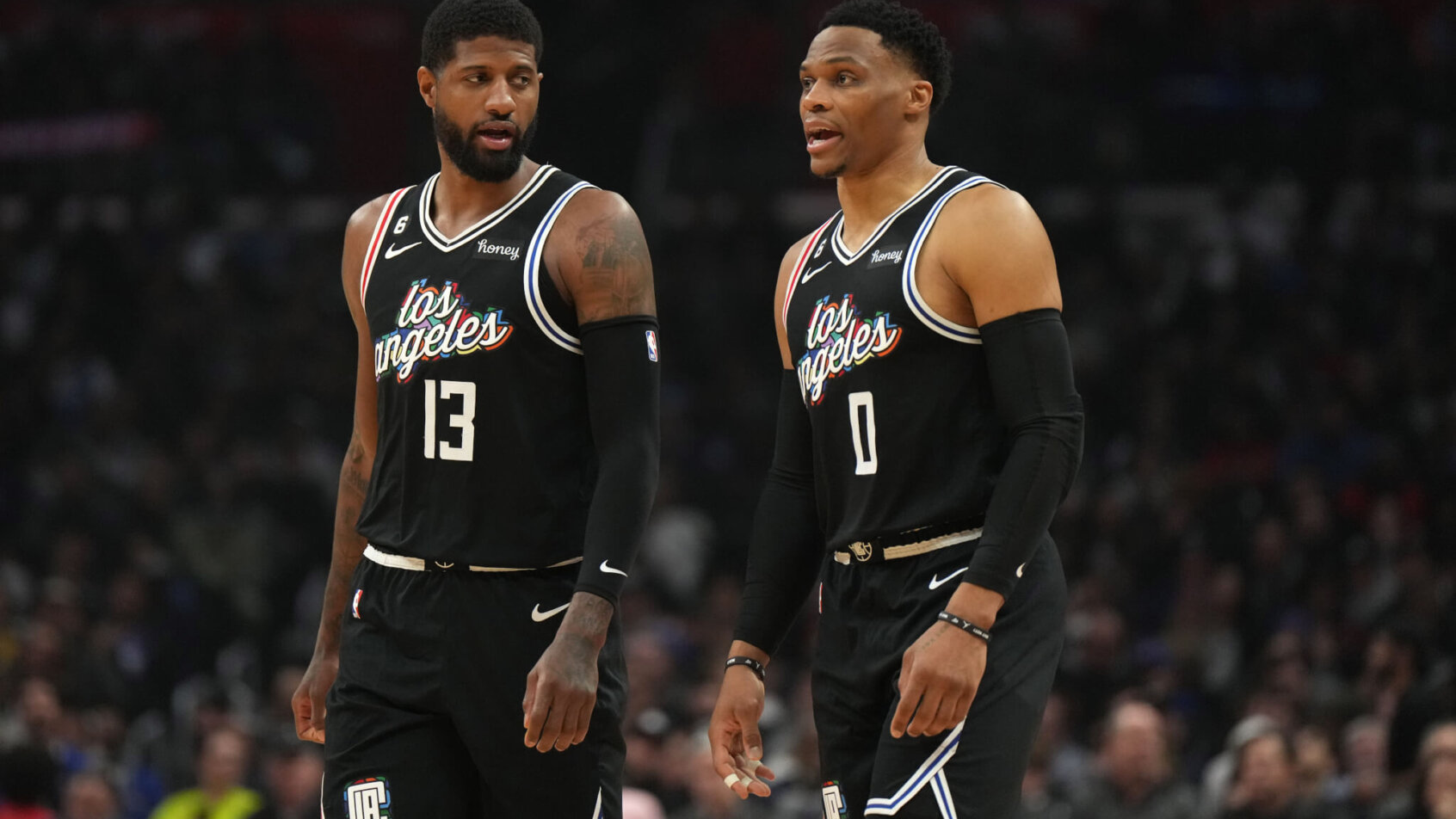 Paul George standing beside Russell Westbrook