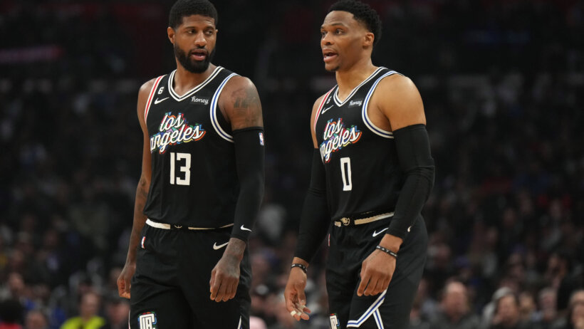 Paul George standing beside Russell Westbrook