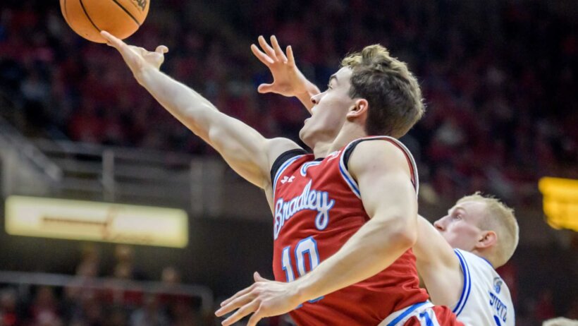 Connor Hickman drives to the hoop versus Drake