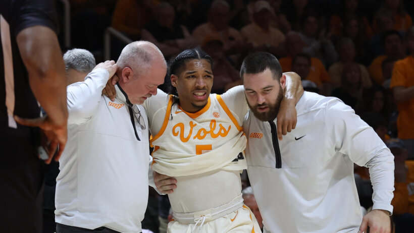Tennessee Volunteers guard Zakai Zeigler is helped off the court