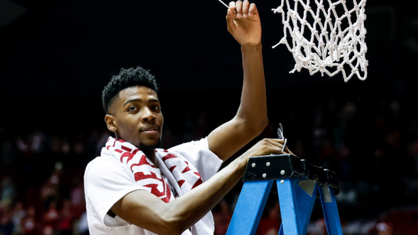 Alabama Crimson Tide forward Brandon Miller cuts down the nets