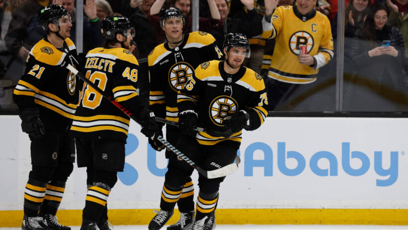 Boston Bruins players celebrate together.