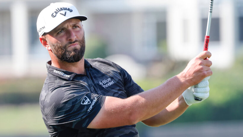 Jon Rahm watching his drive