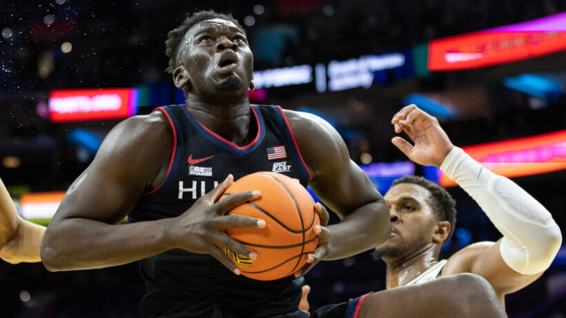 Connecticut Huskies forward Adama Sanogo holds the ball under the hoop