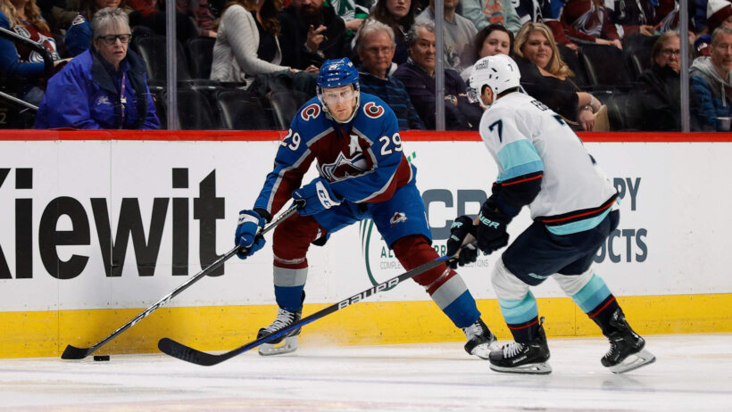 Nathan MacKinnon works along the boards vs the Kraken.