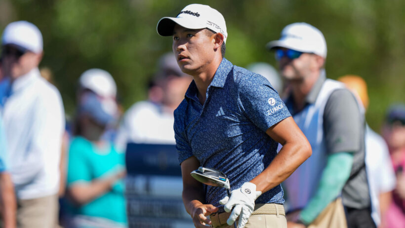 Collin Morikawa watches his tee shot
