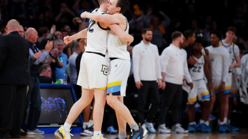 Marquette Golden Eagles guard Tyler Kole hugs forward Michael Kennedy