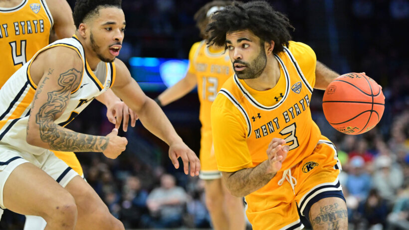 Kent State Golden Flashes guard Sincere Carry dribbles around a defender