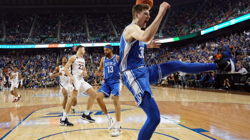 Kyle Filipowski celebrates following a dunk vs Virginia