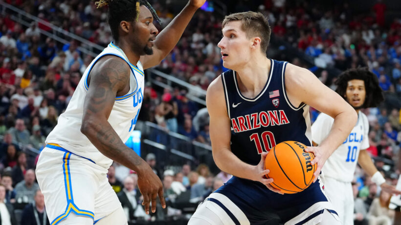 Arizona Wildcats forward Azuolas Tubelis faces a defender
