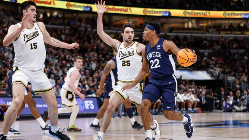 Penn State Nittany Lions guard Jalen Pickett holds off a defender