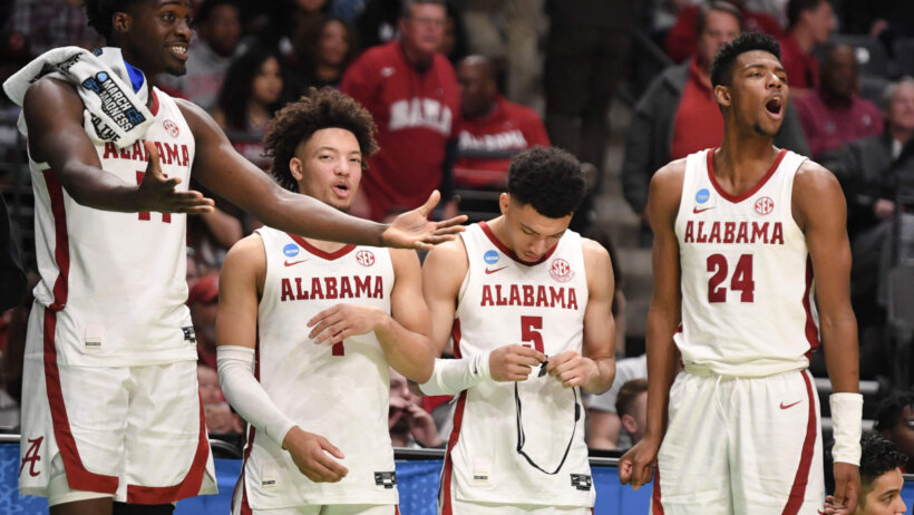 Alabama players celebrating on bench