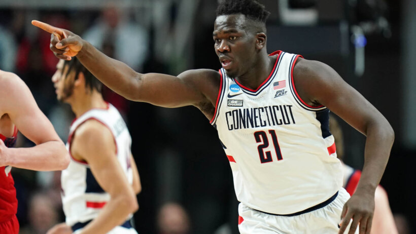 UConn Huskies forward Adama Sanogo points to a teammate