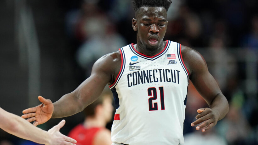UConn Huskies forward Adama Sanogo high fives a teammate