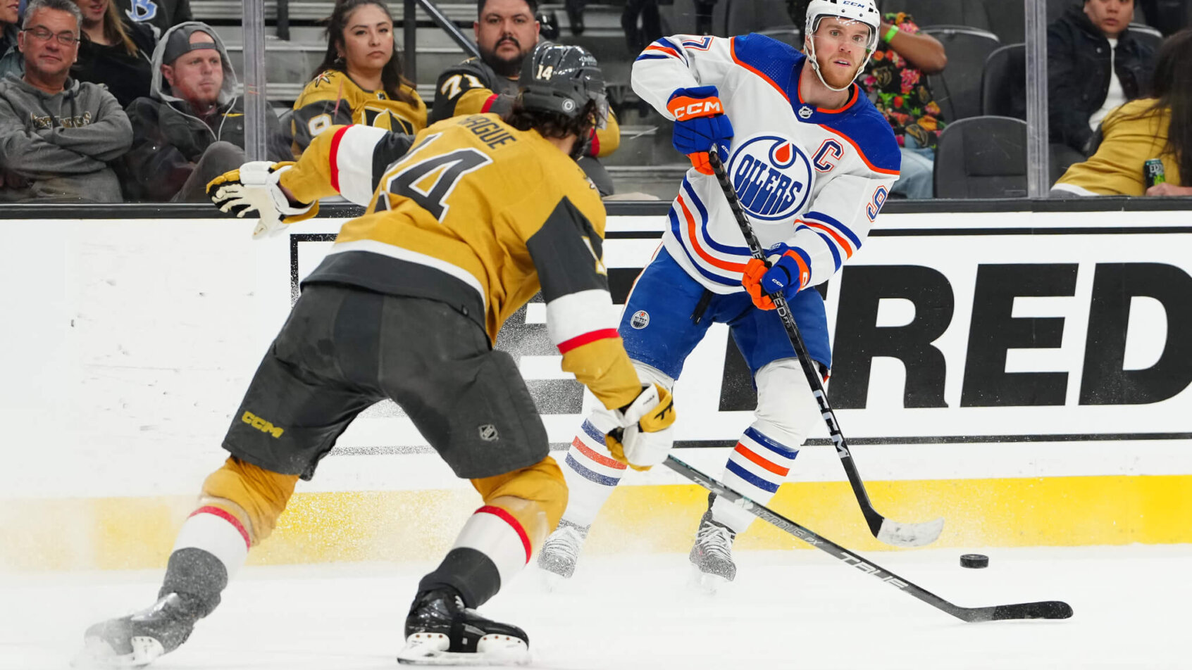 Edmonton Oilers center Connor McDavid sends a pass over the stick of Vegas Golden Knights defenseman Nicolas Hague