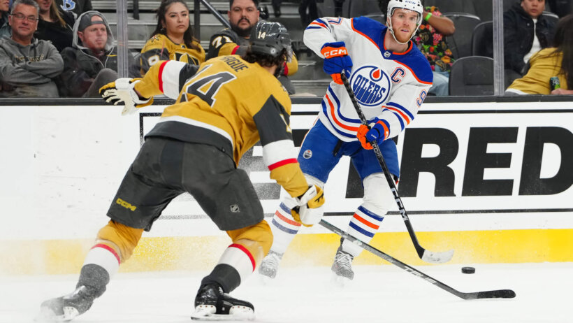 Edmonton Oilers center Connor McDavid sends a pass over the stick of Vegas Golden Knights defenseman Nicolas Hague
