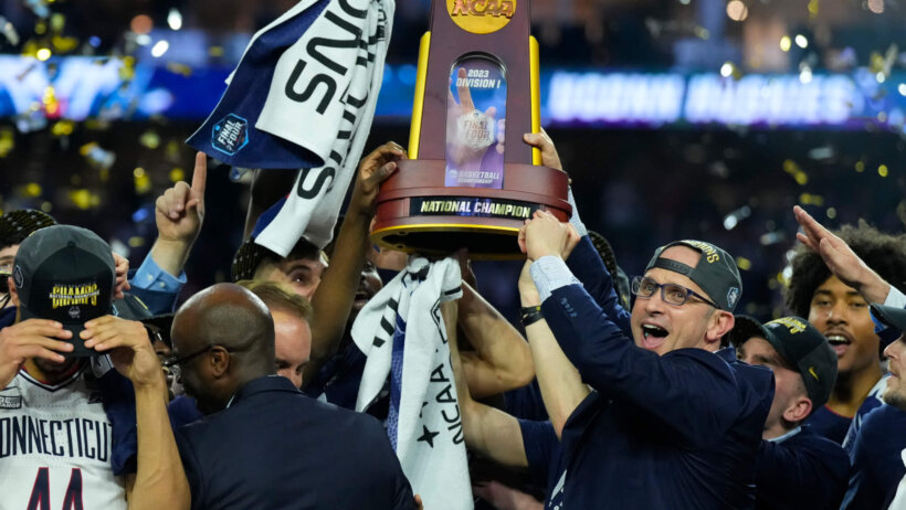 Connecticut Huskies head coach Dan Hurley hoists the national championship trophy