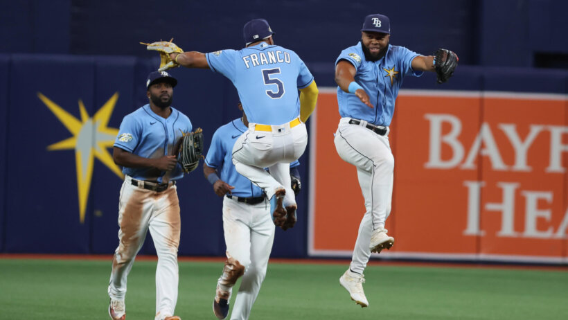 Tampa Bay Rays players celebrating in the outfield.