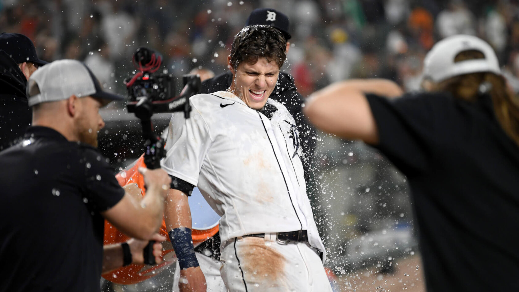 Nick Maton of the Detroit Tigers laughing as he gets water thrown on his after hitting a walkoff.