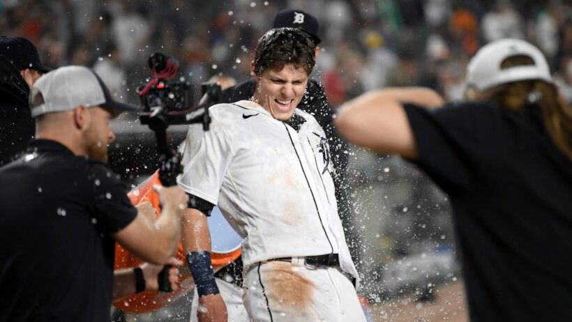 Nick Maton of the Detroit Tigers laughing as he gets water thrown on his after hitting a walkoff.