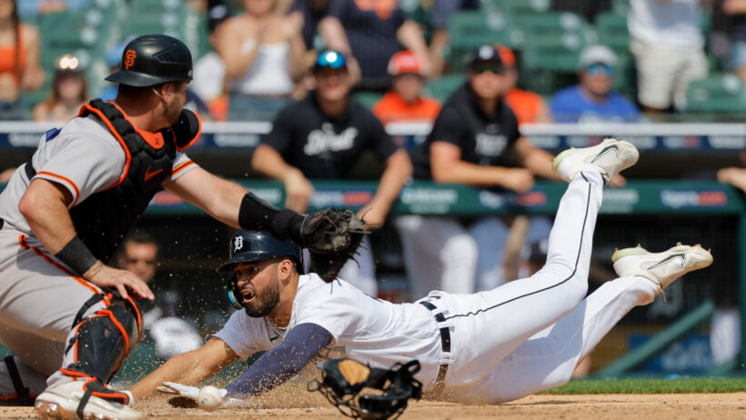 Riley Greene slides into home plate safely