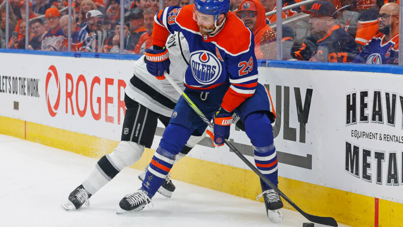 Edmonton Oilers forward Leon Draisaitl battles for a loose puck with Los Angeles Kings defensemen Matt Roy