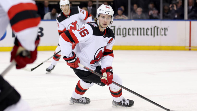 New Jersey Devils center Jack Hughes controls the puck against the New York Rangers