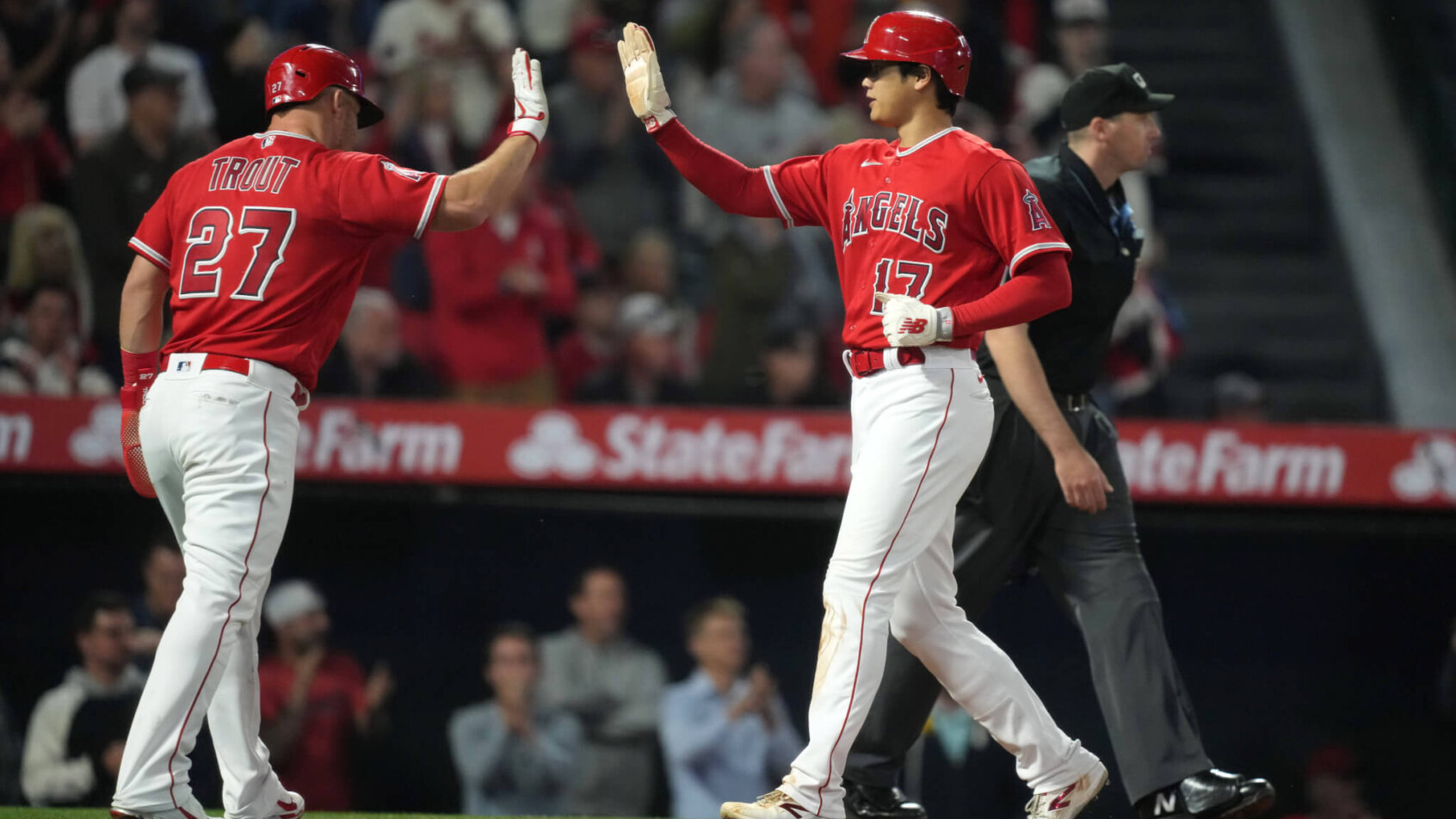 Los Angeles Angels center fielder Mike Trout high-fives designated hitter Shohei Ohtani