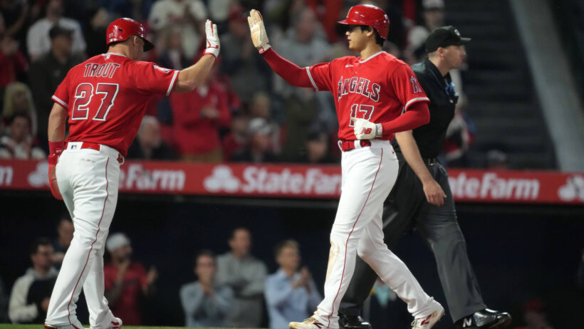 Los Angeles Angels center fielder Mike Trout high-fives designated hitter Shohei Ohtani