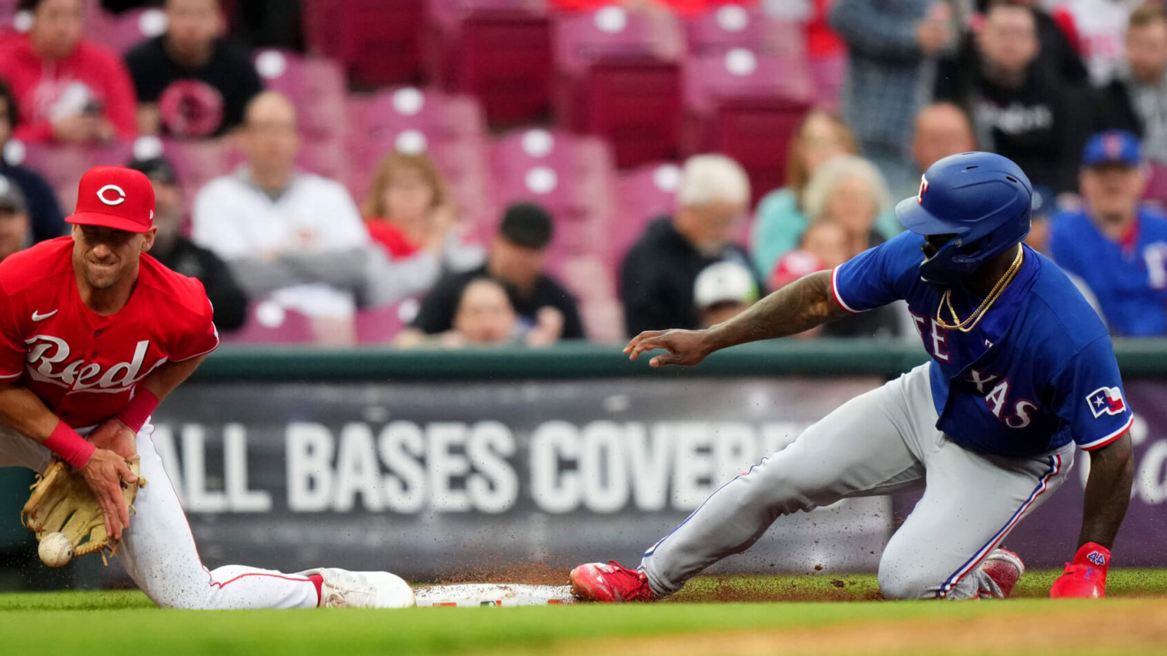 Adolis Garcia slides safely into third base
